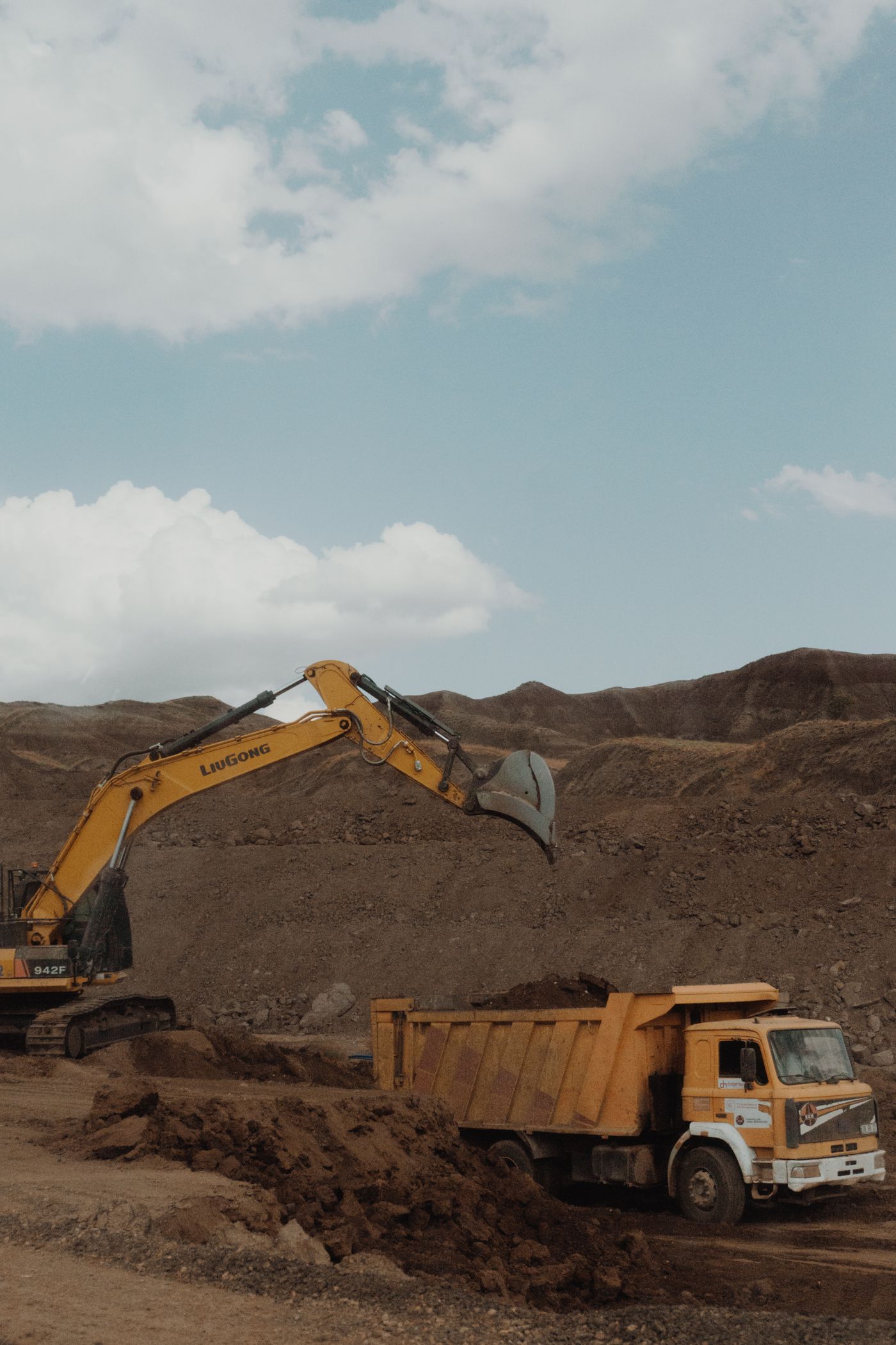 Excavator and dump truck working on an earthmoving site